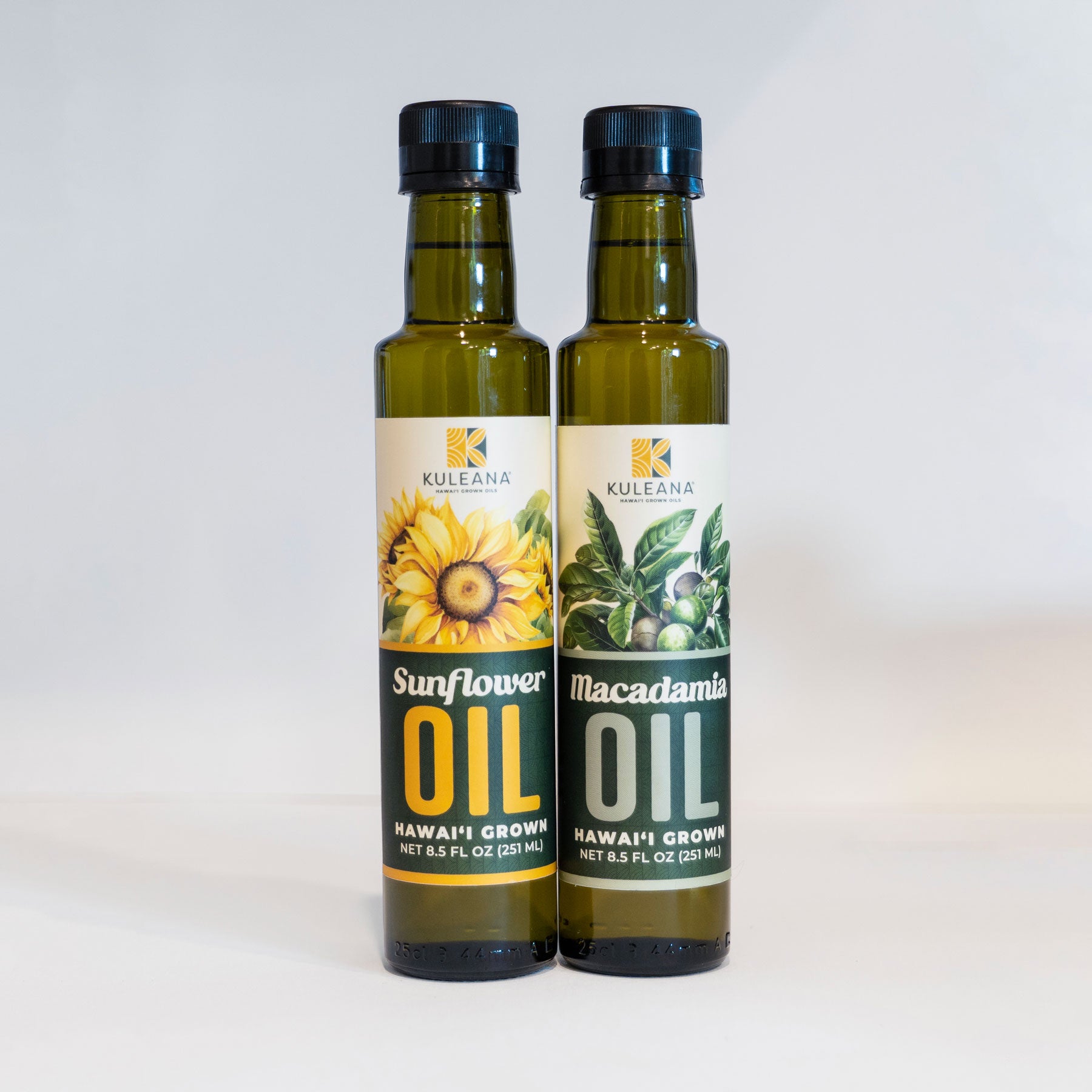 Two bottles of Kuleana oils, one sunflower and one macadamia, on a light gray background.